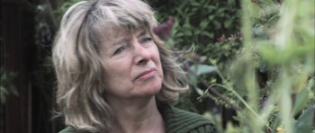 Movie still from “Down Terrace” (2009), directed by Ben Wheatley – An older woman is looking off into the distance; Close Up shot, Low angle