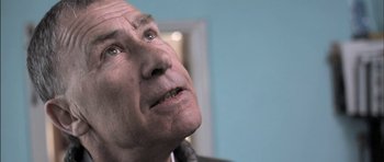 Movie still from “Down Terrace” (2009), directed by Ben Wheatley – An older man looking up into the sky; Close Up shot, Low angle