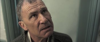 Movie still from “Down Terrace” (2009), directed by Ben Wheatley – An older man looking up into the air; Close Up shot, Low angle