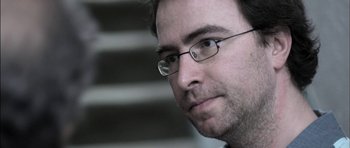 Movie still from “Down Terrace” (2009), directed by Ben Wheatley – A person wearing glasses; Close Up shot, Low angle