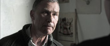 Movie still from “Down Terrace” (2009), directed by Ben Wheatley – An older man is looking into the camera; Close Up shot, Low angle