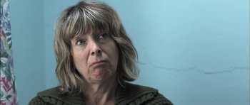 Movie still from “Down Terrace” (2009), directed by Ben Wheatley – A person wearing a sweater; Close Up shot, Low angle