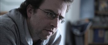 Movie still from “Down Terrace” (2009), directed by Ben Wheatley – A person wearing glasses; Close Up shot, Low angle