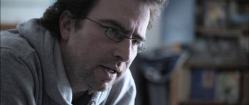 Movie still from “Down Terrace” (2009), directed by Ben Wheatley – A person wearing glasses; Close Up shot, Low angle