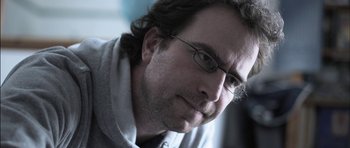 Movie still from “Down Terrace” (2009), directed by Ben Wheatley – A person wearing glasses; Close Up shot, Low angle