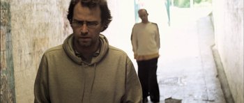 Movie still from “Down Terrace” (2009), directed by Ben Wheatley – Two men standing in front of each other; Medium shot, Low angle