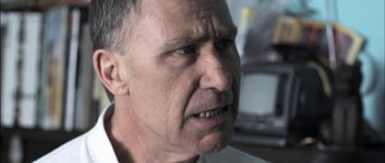 Movie still from “Down Terrace” (2009), directed by Ben Wheatley – An older man with a frowning look on his face; Close Up shot, Low angle