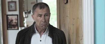 Movie still from “Down Terrace” (2009), directed by Ben Wheatley – An older man with a concerned look on his face; Close Up shot, Low angle