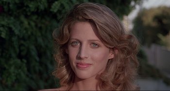A woman's face in front of trees