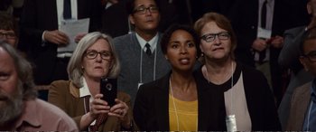 Movie still from “Downsizing” (2017), directed by Alexander Payne – A group of people sitting in front of each other; Medium shot, Over the shoulder angle