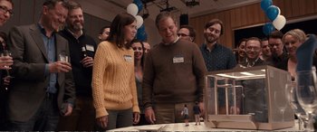 Movie still from “Downsizing” (2017), directed by Alexander Payne – A man and woman standing next to each other in a room; Wide shot, Over the shoulder angle