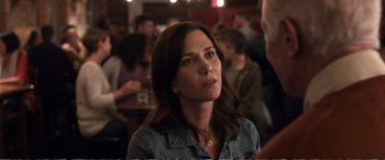 Movie still from “Downsizing” (2017), directed by Alexander Payne – A person sitting in front of a group of people; Close Up shot, Over the shoulder angle