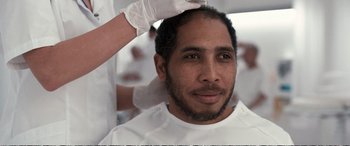 Movie still from “Downsizing” (2017), directed by Alexander Payne – A person getting his hair cut; Close Up shot, Over the shoulder angle