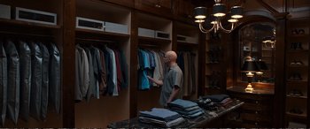 Movie still from “Downsizing” (2017), directed by Alexander Payne – A bald man in a store looking at clothes; Wide shot, High angle
