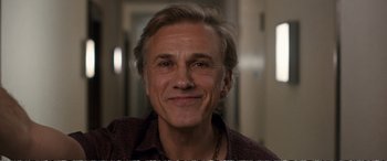 Movie still from “Downsizing” (2017), directed by Alexander Payne – A person smiling for the camera; Close Up shot, Low angle