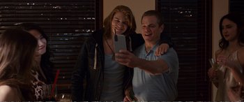 Movie still from “Downsizing” (2017), directed by Alexander Payne – A man and a woman taking a picture with a cell phone; Medium shot, Over the shoulder angle