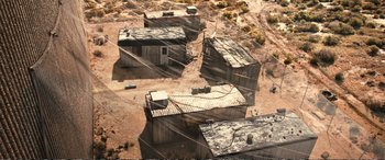 Movie still from “Downsizing” (2017), directed by Alexander Payne – An aerial view of a bunch of buildings in the desert; Extreme Wide shot, High angle