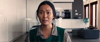 Movie still from “Downsizing” (2017), directed by Alexander Payne – A woman in a green shirt is looking at the camera; Close Up shot, High angle