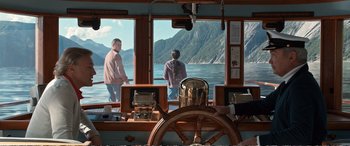 Movie still from “Downsizing” (2017), directed by Alexander Payne – Two people standing on a boat looking out a window; Wide shot, Over the shoulder angle