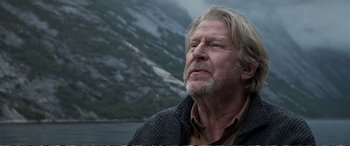 Movie still from “Downsizing” (2017), directed by Alexander Payne – An older man with long white hair looking up; Close Up shot, Low angle