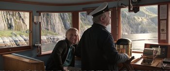 Movie still from “Downsizing” (2017), directed by Alexander Payne – A man and a woman are sitting in front of a window; Medium shot, Over the shoulder angle