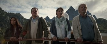 Movie still from “Downsizing” (2017), directed by Alexander Payne – A group of people standing next to each other on top of a boat; Medium shot, Low angle