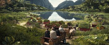 Movie still from “Downsizing” (2017), directed by Alexander Payne – A group of people riding in a wagon down a river; Extreme Wide shot, High angle