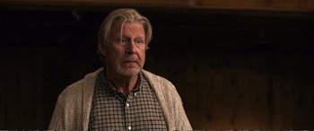 Movie still from “Downsizing” (2017), directed by Alexander Payne – An old man with a beard and a plaid shirt; Close Up shot, Over the shoulder angle