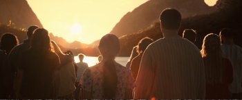Movie still from “Downsizing” (2017), directed by Alexander Payne – A group of people standing in front of a body of water; Extreme Wide shot, Over the shoulder angle