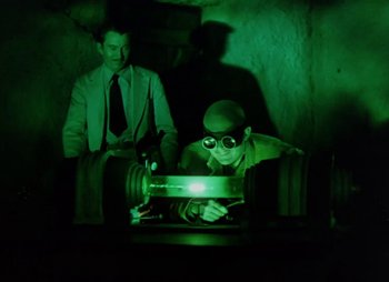 Movie still from “Dr. Cyclops” (1940), directed by Ernest B. Schoedsack – A man sitting in front of a computer screen; Medium shot, Low angle