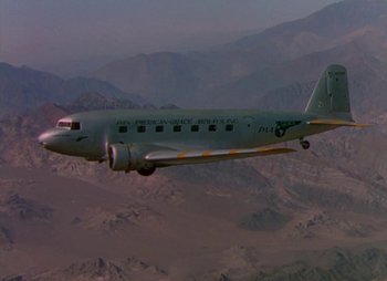 Movie still from “Dr. Cyclops” (1940), directed by Ernest B. Schoedsack – An airplane is flying in the sky over the mountains; Extreme Wide shot, Low angle
