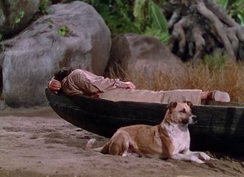 Movie still from “Dr. Cyclops” (1940), directed by Ernest B. Schoedsack – A man and a dog laying in a canoe; Wide shot, High angle