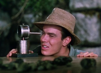 Movie still from “Dr. Cyclops” (1940), directed by Ernest B. Schoedsack – A young man wearing a hat looking into a mirror; Close Up shot, High angle