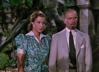 Movie still from “Dr. Cyclops” (1940), directed by Ernest B. Schoedsack – A man and a woman standing next to each other; Medium shot, Low angle