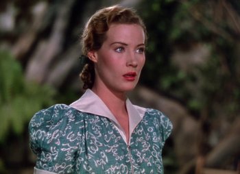 Movie still from “Dr. Cyclops” (1940), directed by Ernest B. Schoedsack – A woman in a green dress standing in front of a tree; Close Up shot, Low angle