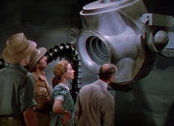 Movie still from “Dr. Cyclops” (1940), directed by Ernest B. Schoedsack – A group of people standing next to each other in a room; Medium shot, Low angle