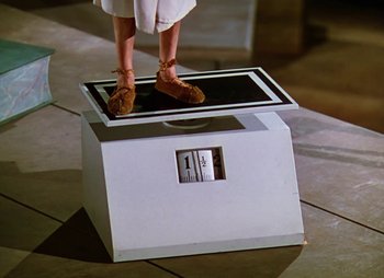 Movie still from “Dr. Cyclops” (1940), directed by Ernest B. Schoedsack – A woman standing on top of a white box; Medium shot, Low angle