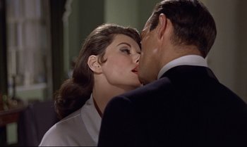 Movie still from “Dr. No” (1962), directed by Terence Young – A man and a woman kissing in front of a mirror; Close Up shot, Over the shoulder angle