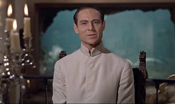 Movie still from “Dr. No” (1962), directed by Terence Young – A person wearing a suit; Medium shot, Low angle