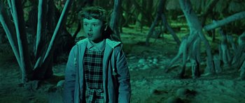 Movie still from “Dr. Who and the Daleks” (1965), directed by Gordon Flemyng – A young girl standing in the woods at night; Medium shot, High angle