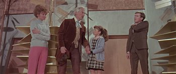 Movie still from “Dr. Who and the Daleks” (1965), directed by Gordon Flemyng – An older man and a young girl holding hands; Medium shot, Low angle