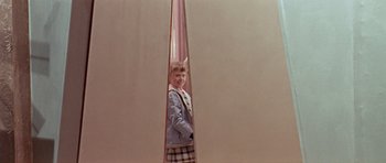 Movie still from “Dr. Who and the Daleks” (1965), directed by Gordon Flemyng – A young girl standing inside a pink pole; Medium shot, Low angle