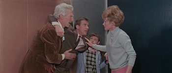 Movie still from “Dr. Who and the Daleks” (1965), directed by Gordon Flemyng – A group of people standing next to each other in a room; Medium shot, Low angle