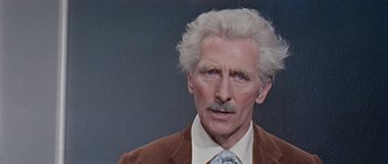 Movie still from “Dr. Who and the Daleks” (1965), directed by Gordon Flemyng – An old man with a mustache and a beard; Close Up shot, Over the shoulder angle