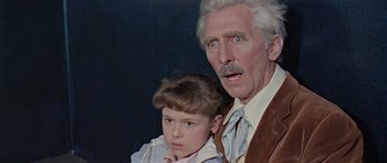 Movie still from “Dr. Who and the Daleks” (1965), directed by Gordon Flemyng – An older man and a young boy standing next to each other; Close Up shot, Over the shoulder angle