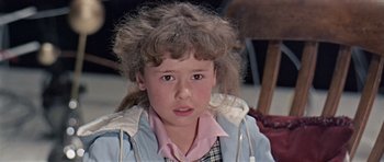 Movie still from “Dr. Who and the Daleks” (1965), directed by Gordon Flemyng – A young girl with messy hair and a pink shirt; Close Up shot, High angle