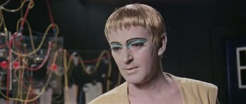 Movie still from “Dr. Who and the Daleks” (1965), directed by Gordon Flemyng – A man with makeup on his face and hair; Close Up shot, Low angle