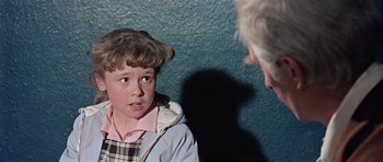 Movie still from “Dr. Who and the Daleks” (1965), directed by Gordon Flemyng – A young girl is being interviewed by an older man; Close Up shot, Over the shoulder angle