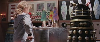 Movie still from “Dr. Who and the Daleks” (1965), directed by Gordon Flemyng – A group of lava lamps sitting on top of a table; Medium shot, Low angle