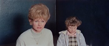 Movie still from “Dr. Who and the Daleks” (1965), directed by Gordon Flemyng – A woman and a boy are sitting next to each other; Close Up shot, Low angle